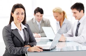 Business team working with laptop, woman on foreground.